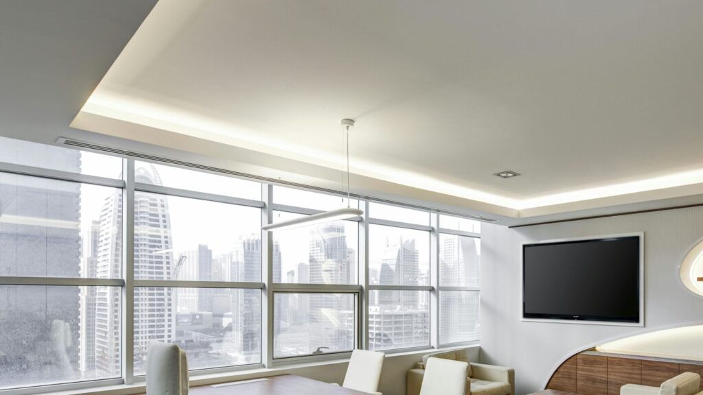 Sleek office space featuring contemporary furniture and city skyline views, ideal for professionals.